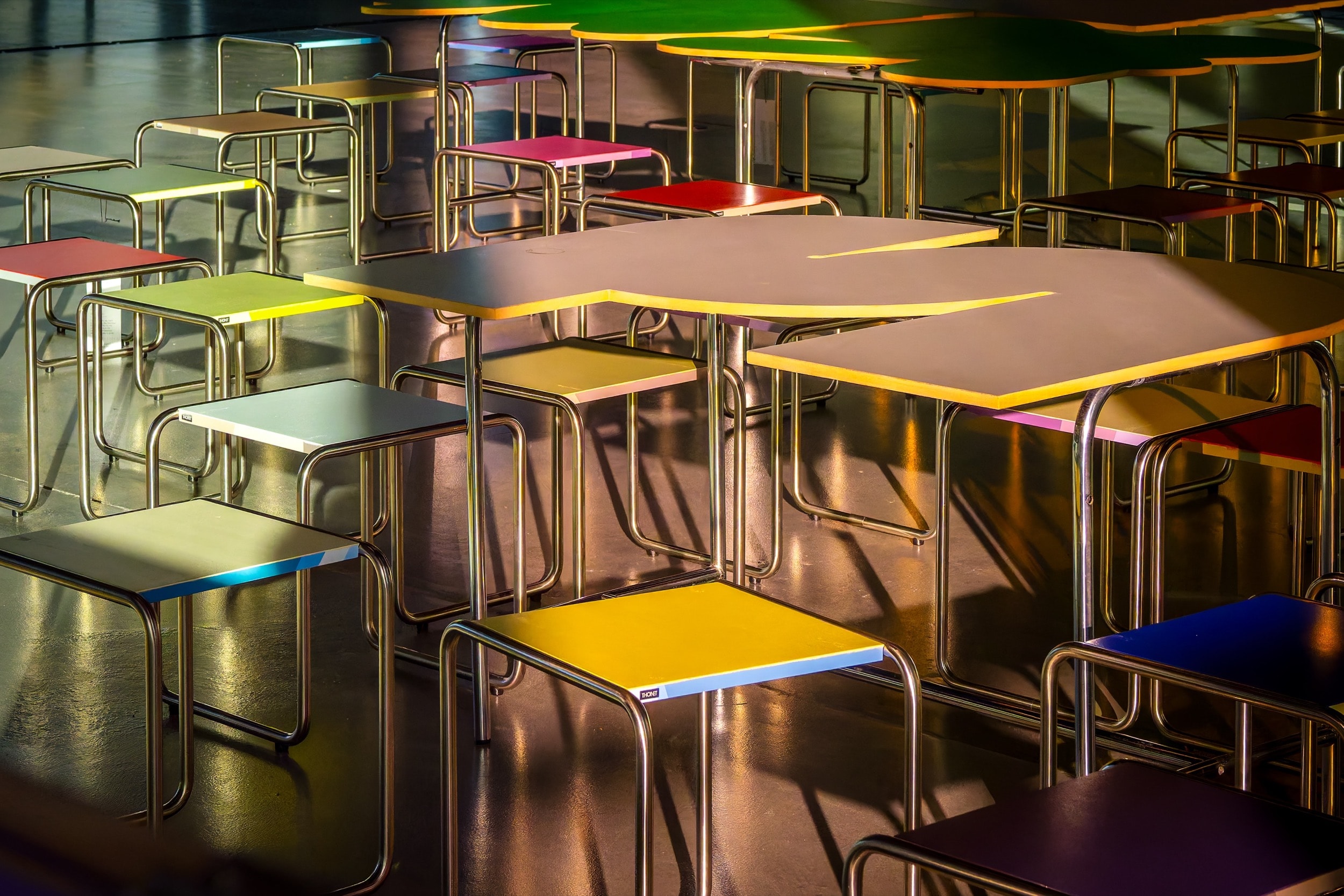 Vibrant classroom furniture in yellow, pink, and green exploring learning environment design concepts